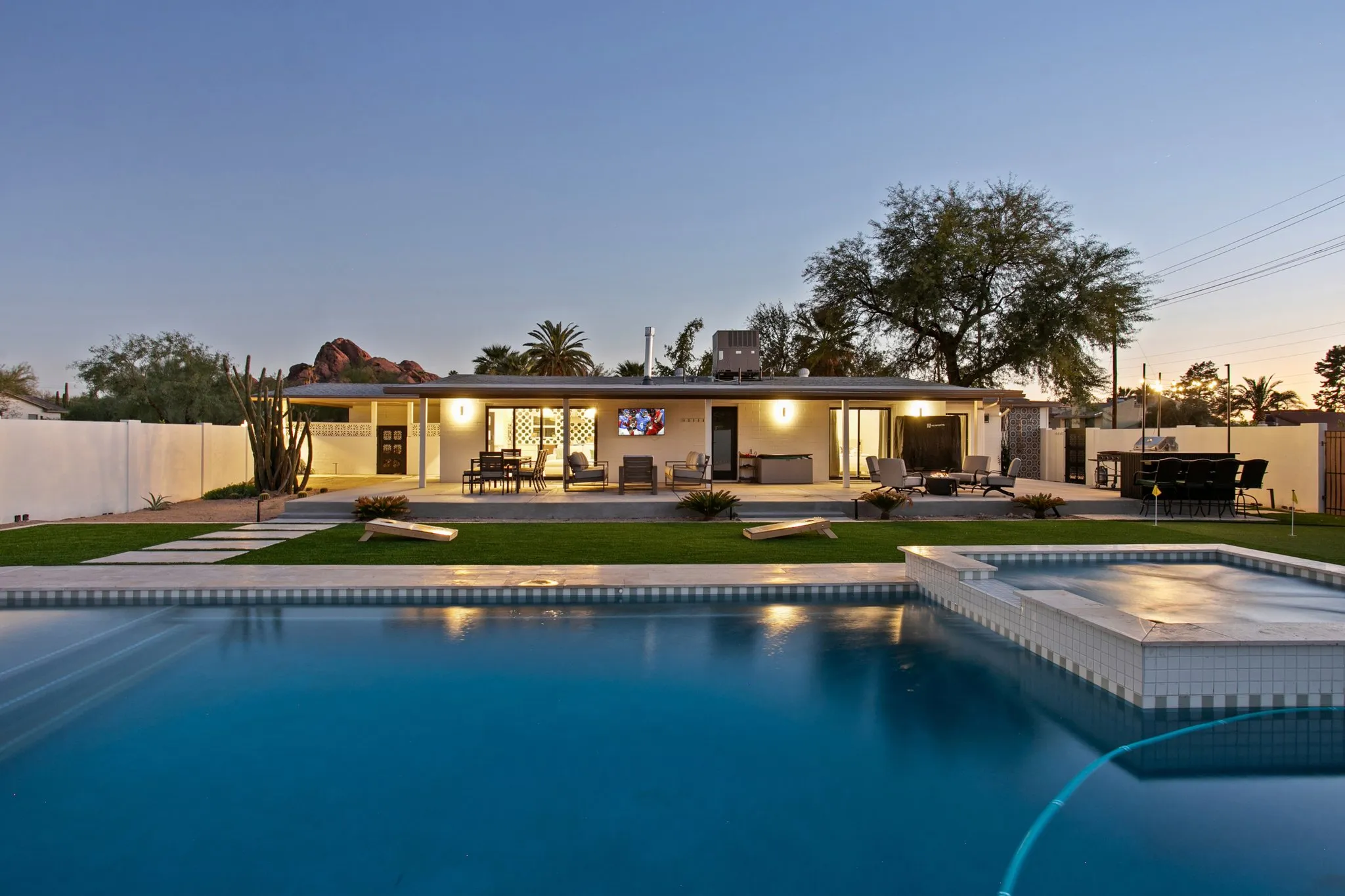 Backyard pool at dusk with Camelback Mountain views at a Klassi Properties Scottsdale vacation rental